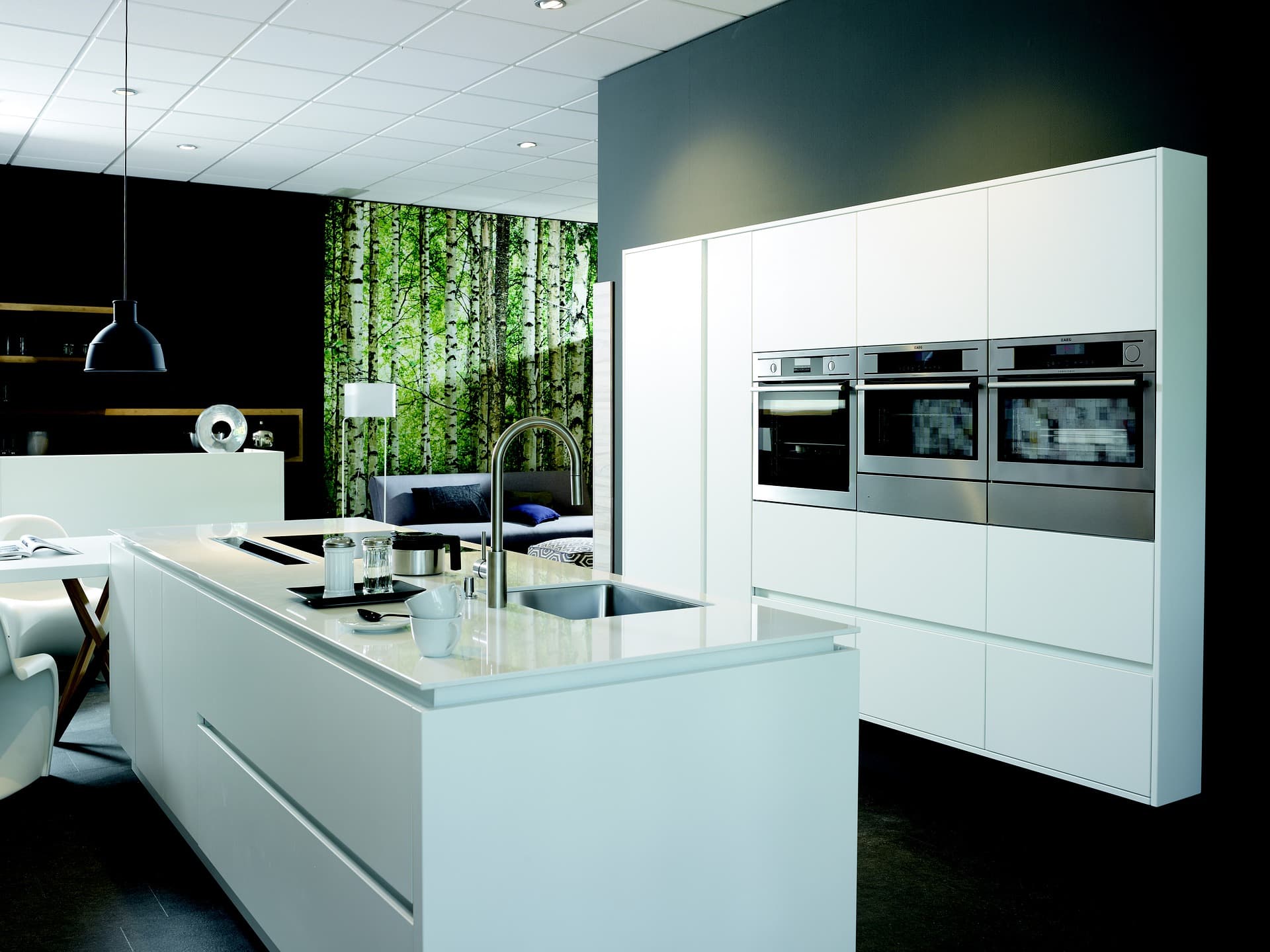 Professional appliance repair technicians working in modern kitchen